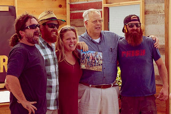 Image of Ashley Morrill with rest of the Maine Cabin Masters cast