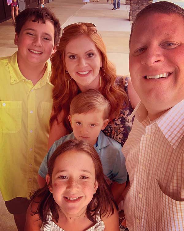 Image of Ashley Jones with her husband and her children.
